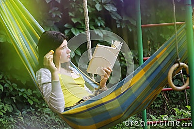 Serene scene with teen girl in hammock with apricot reading book Stock Photo