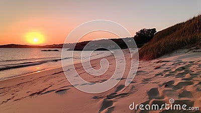 A serene sunset over a beach with soft pinks and oranges Stock Photo