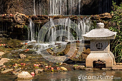 Japanese Waterfall with Stone Lantern Stock Photo