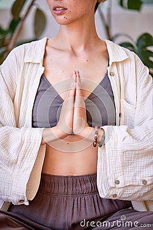 Serenity And Mindfulness Concept. Portrait of cropped european female holding hands together Stock Photo