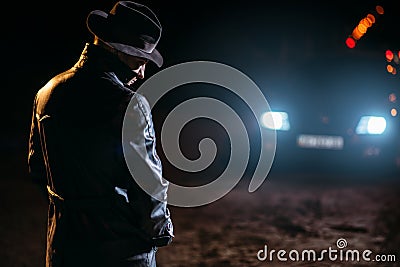 Maniac in black leather coat and hat, back view Stock Photo
