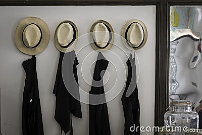 A series of Apron and sombrero mexican hat at the front door entrance of a small restaurant in Lisbon. Business concept and Stock Photo