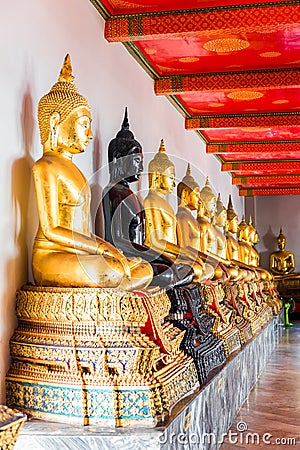 A series of seated Buddhas in a Thai temple Stock Photo