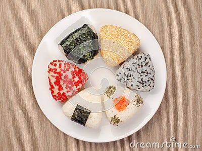 A series of shots of onigiri of various shapes and fillings on a plate. Top view. Japanese rice ball Stock Photo