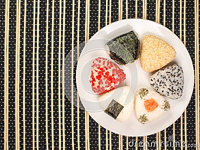 A series of shots of onigiri of various shapes and fillings on a plate. Top view. Japanese rice ball Stock Photo