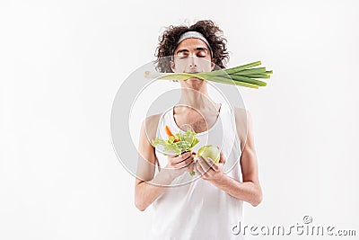 Serine slim young man with healthy food Stock Photo