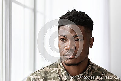 Serious african american man soldier looking through the window Stock Photo