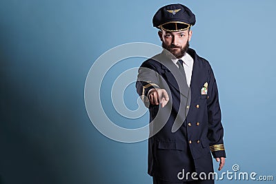 Serious aircraft pilot pointing at camera Stock Photo