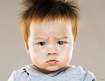 Serious asia baby boy eyebrow frown Stock Photo