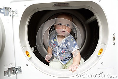Serious baby in the dryer Stock Photo