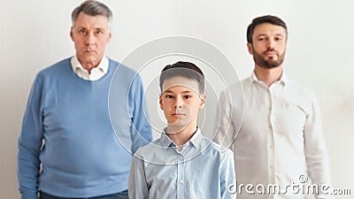 Serious Boy, Father And Grandfather Standing Over White Background, Panorama Stock Photo