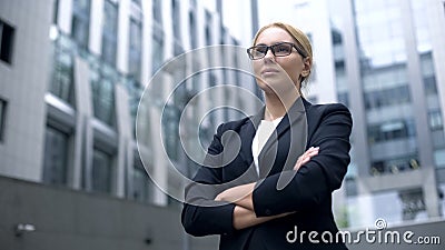 Serious business lady smiling, arms crossed, professionalism and experience Stock Photo