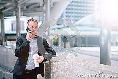 Serious business man talking on cell phone at modern city. Stock Photo