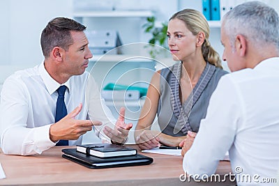 Serious business people speaking at meeting Stock Photo