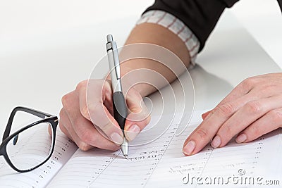 Serious business woman writting on her agenda in the office Stock Photo