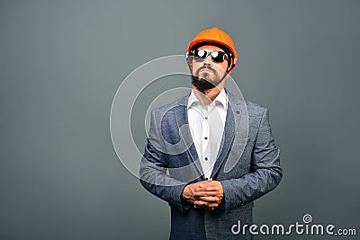 Serious businessman builder on a grey background Stock Photo