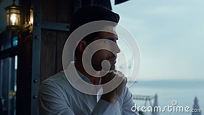 Serious businessman looking seascape resting luxury panoramic cafe alone profile Stock Photo