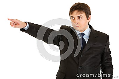 Serious businessman pointing finger in corner Stock Photo