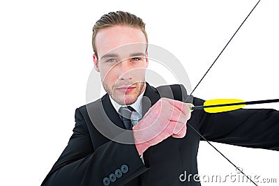 Serious businessman shooting a bow and arrow Stock Photo