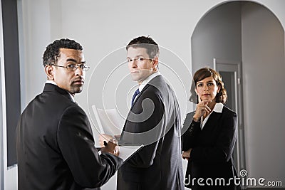 Serious businesspeople looking over shoulder Stock Photo