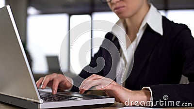 Serious businesswoman working on laptop, career and employment concept, closeup Stock Photo