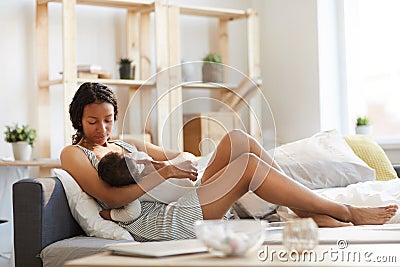 Black mom breastfeeding baby Stock Photo