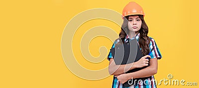 serious child in construction helmet hold in clipboard, expertise. Child builder in helmet horizontal poster design Stock Photo