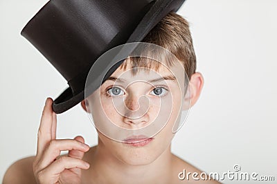 Serious child tipping his hat on head Stock Photo