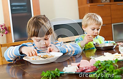 Serious children eating food Stock Photo