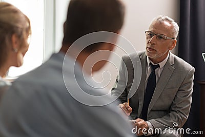 Serious concentrated psychoanalyst assessing his patients mental health Stock Photo