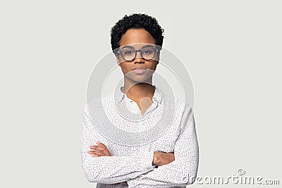 Serious concentrated young african american girl standing with folded hands. Stock Photo