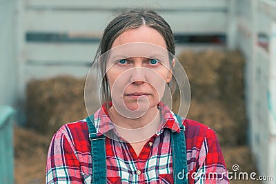 Serious concerned female farmer posing on farm Stock Photo