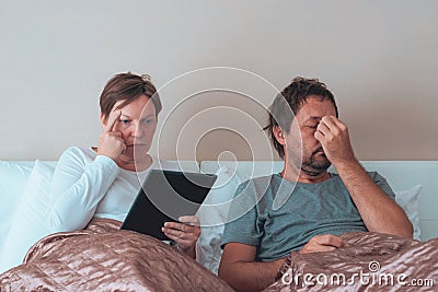 Serious couple, husband and wife in bedroom Stock Photo