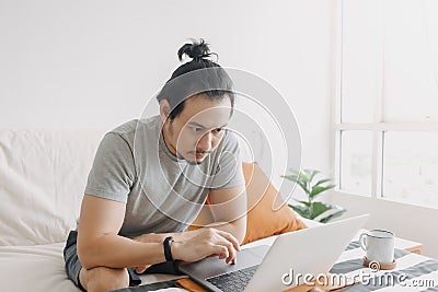 Serious creative man work in his home office apartment. Stock Photo