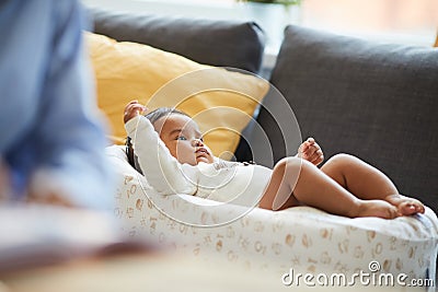 Serious cute baby in cocoon for safety Stock Photo