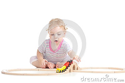 Serious cute child is playing with train Stock Photo