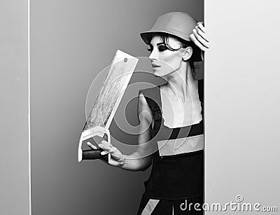 Serious cute sexy builder girl on colorful studio background, copy space Stock Photo