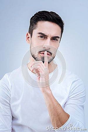 Serious demanding teacher asking his students to be quiet at the lesson Stock Photo