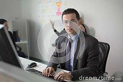 Serious devoted business man work in office on computer. Real economist business people, not models. Bank employees discussing Stock Photo