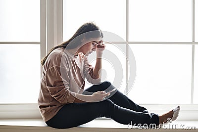 Serious and distressed woman using a smartphone Stock Photo