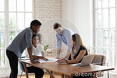 Serious diverse business people working on project documents at meeting Stock Photo