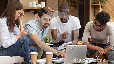 Serious diverse friends study together with laptop notebooks in cafe Stock Photo