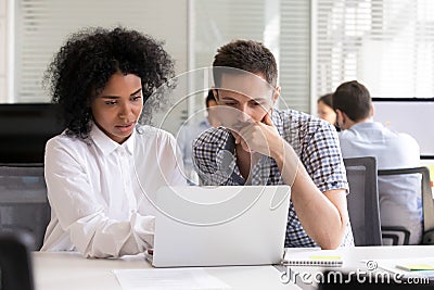 Serious diverse office colleagues discussing online project resu Stock Photo