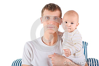 Serious father with baby is sitting on chair Stock Photo