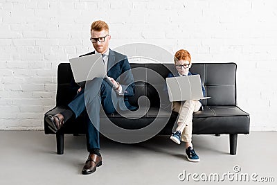 serious father and little son businessmen wearing eyeglasses Stock Photo