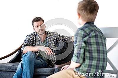 Serious father looking at little son Stock Photo