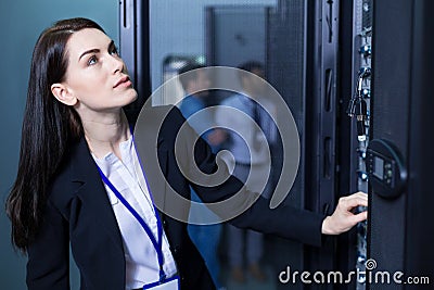 Serious intelligent woman working with informational technology Stock Photo