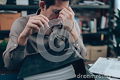 Serious Investors have a headache while working on the desk. Accounting and Financial concept Stock Photo