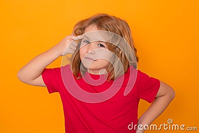 Serious kid thinking on studio isolated background. Think and idea. Thoughtful kid studio portrait. Doubt and concerned Stock Photo