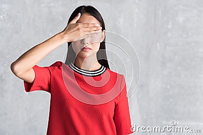 Serious lady putting arm on face Stock Photo